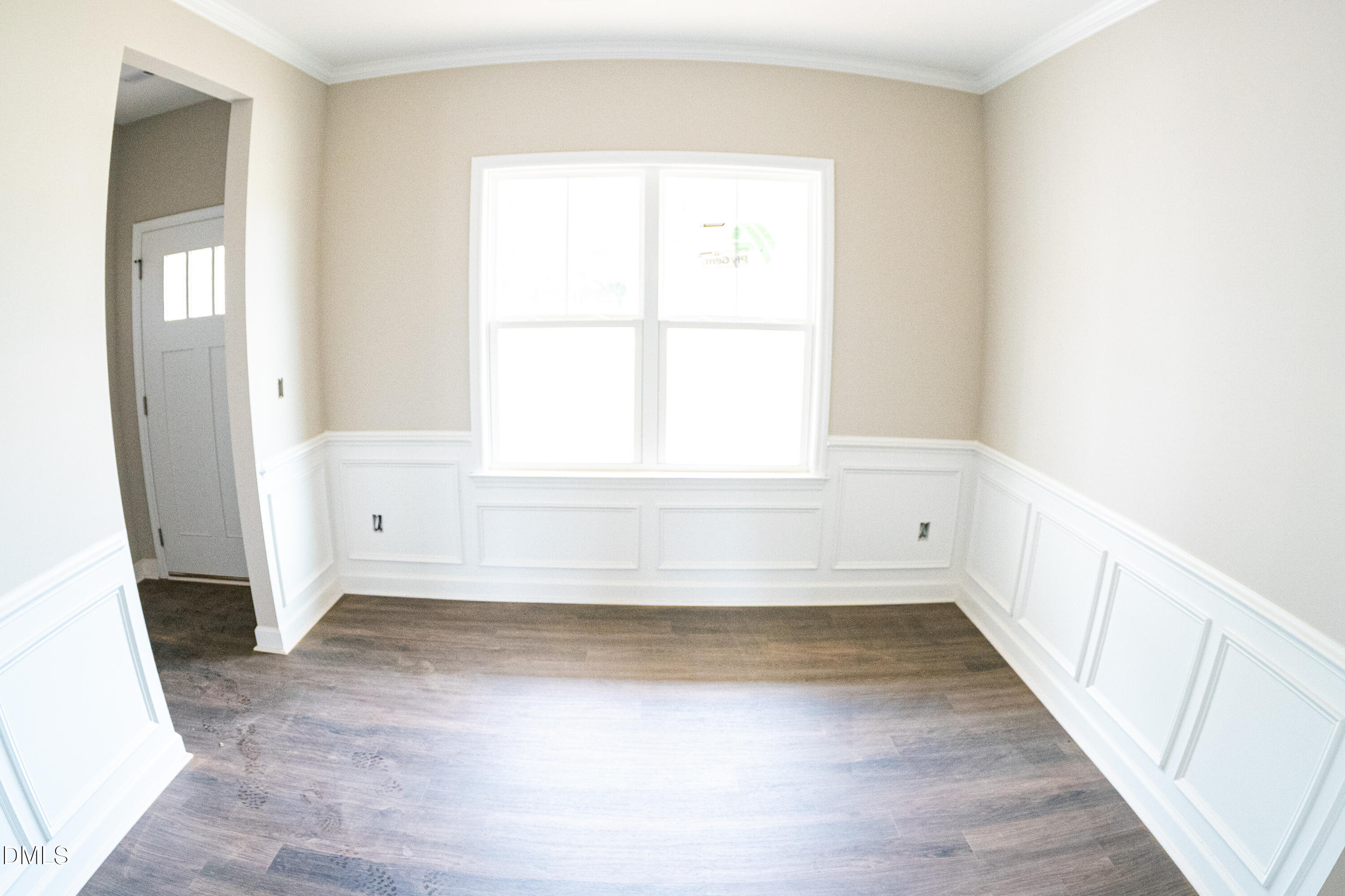 125 Wilson Street Erwin, NC 28339 - Photo 10 of 22 a view of an empty room with wooden floor and a window