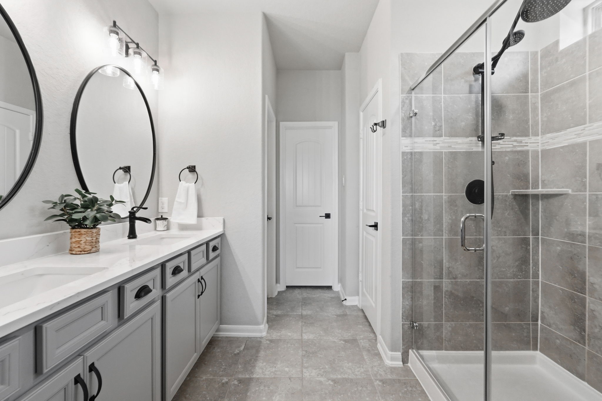 4334 Umber Shadow Drive Spring, TX 77386 - Photo 5 of 45 Primary bathroom features dual vanities, framed mirrors, a walk-in glass shower, and contemporary finishes throughout.
