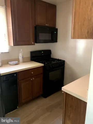 a bathroom with a sink a window and cabinets