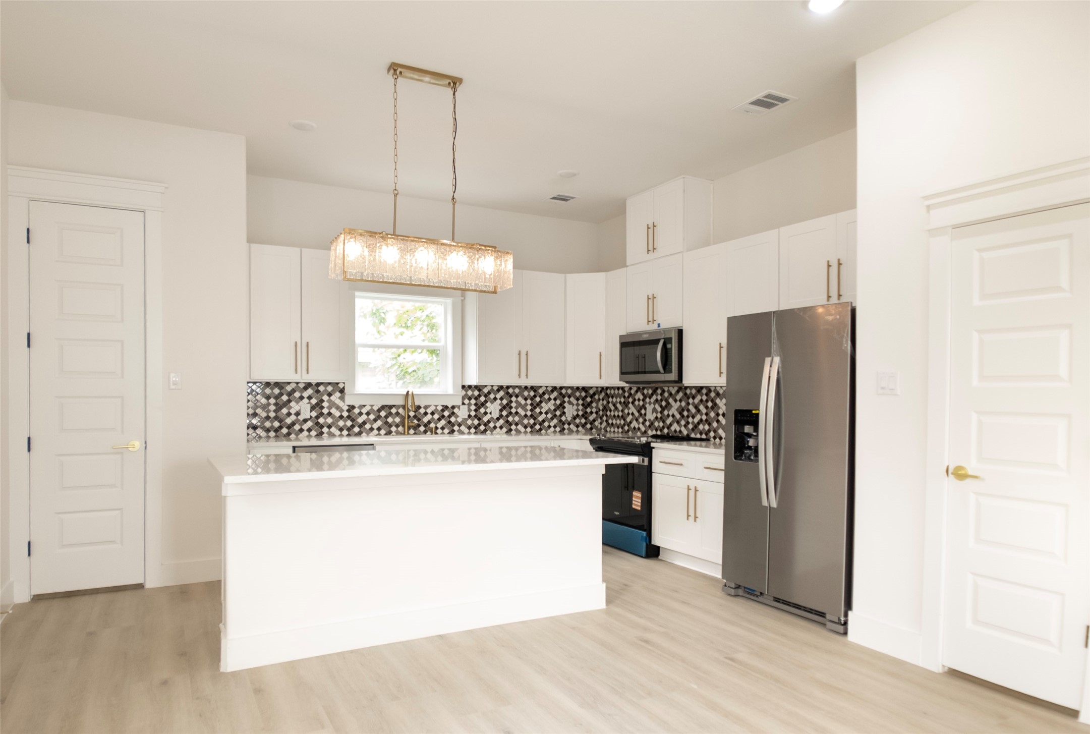 823 North Loop Houston, TX 77022 - Photo 5 of 23 a kitchen with stainless steel appliances granite countertop a stove a refrigerator and a refrigerator