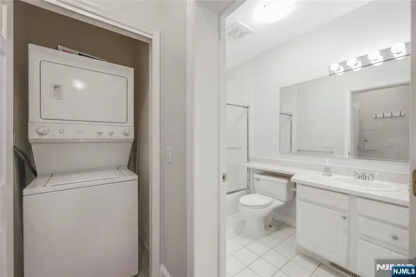 a view of bathroom with a toilet sink and a mirror