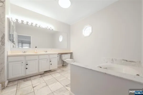 a spacious bathroom with a double vanity sink mirror and