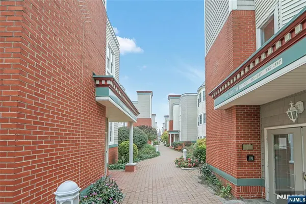 a view of a pathway both side of house