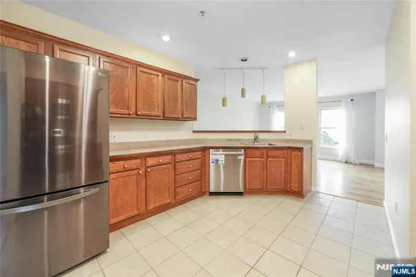 a kitchen with stainless steel appliances granite countertop a refrigerator sink and cabinets