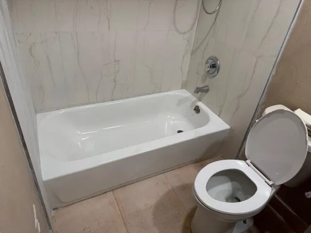 a room with a bed and a mirror