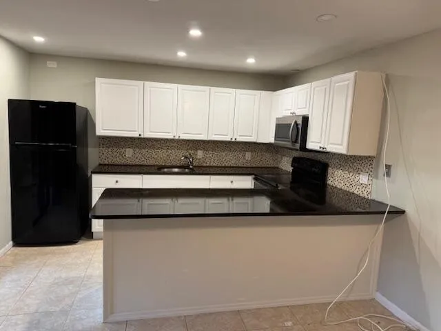 a kitchen with a refrigerator and a sink