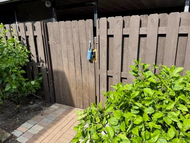 a view of a potted plants covered with wooden fence