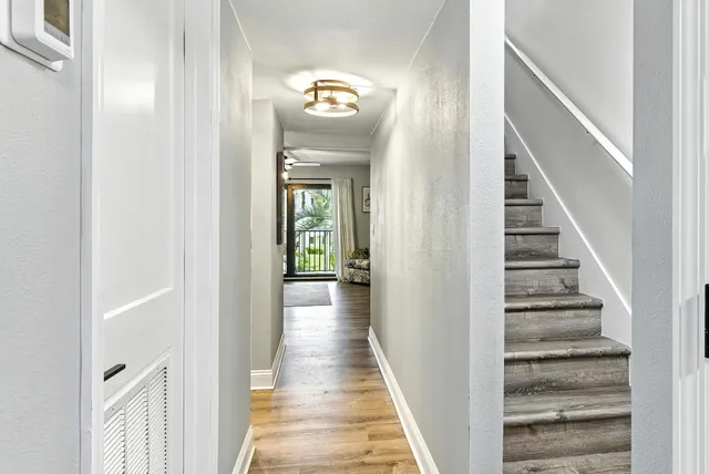 a view of a hallway with wooden floor and entryway