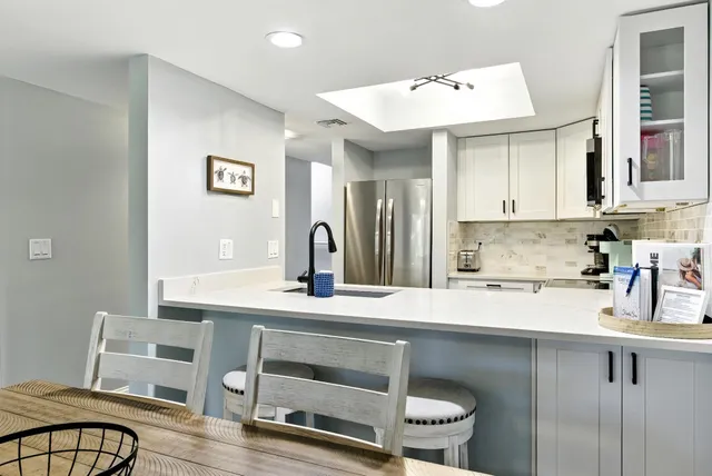 a kitchen with stainless steel appliances granite countertop a refrigerator and a stove top oven