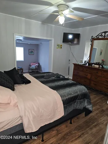 a bedroom with a bed and ceiling fan