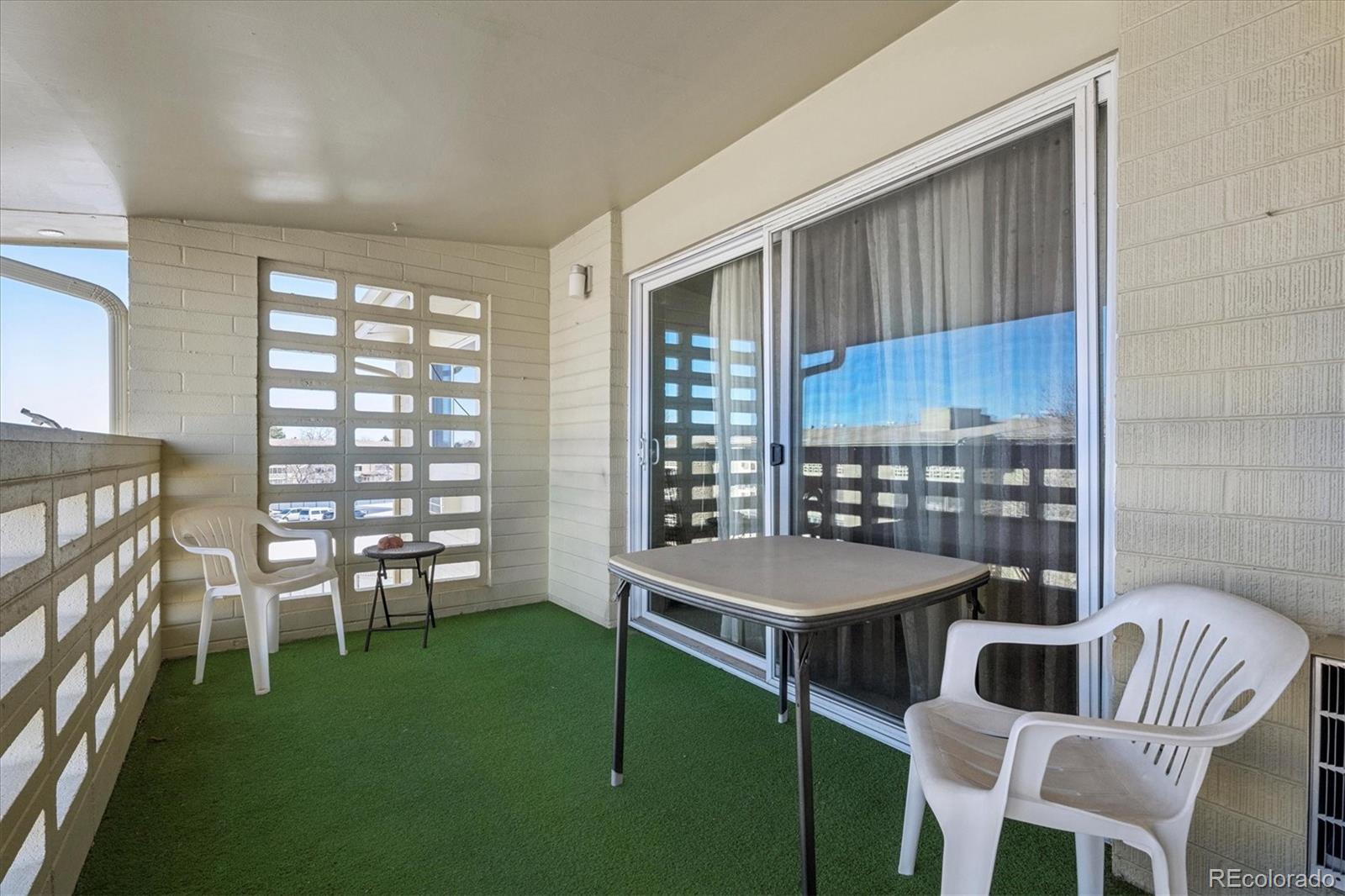 660 South Alton Way, Unit 2D Denver, CO 80247 - Photo 15 of 32 a dining room with furniture and a floor to ceiling window