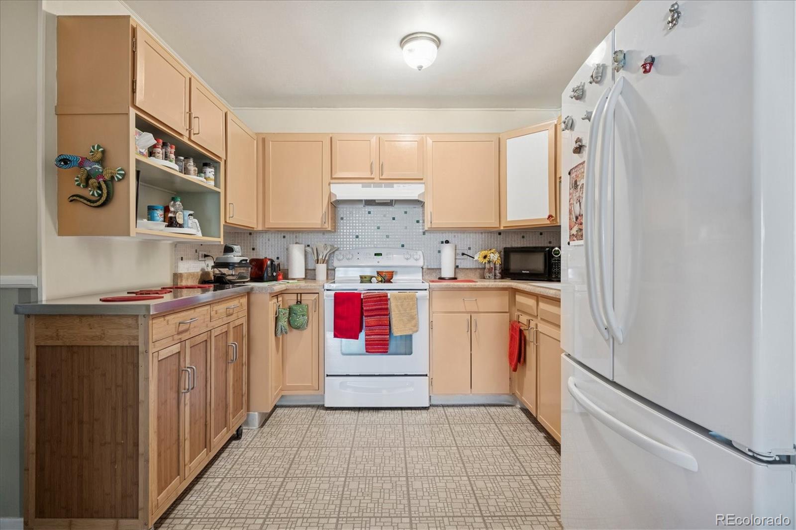 660 South Alton Way, Unit 2D Denver, CO 80247 - Photo 3 of 32 a kitchen with stainless steel appliances granite countertop a stove a sink and a refrigerator