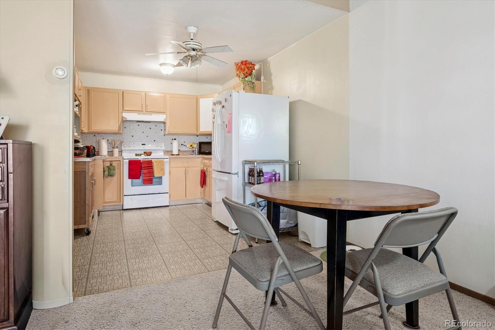 660 South Alton Way, Unit 2D Denver, CO 80247 - Photo 4 of 32 a view of kitchen and dining room with furniture