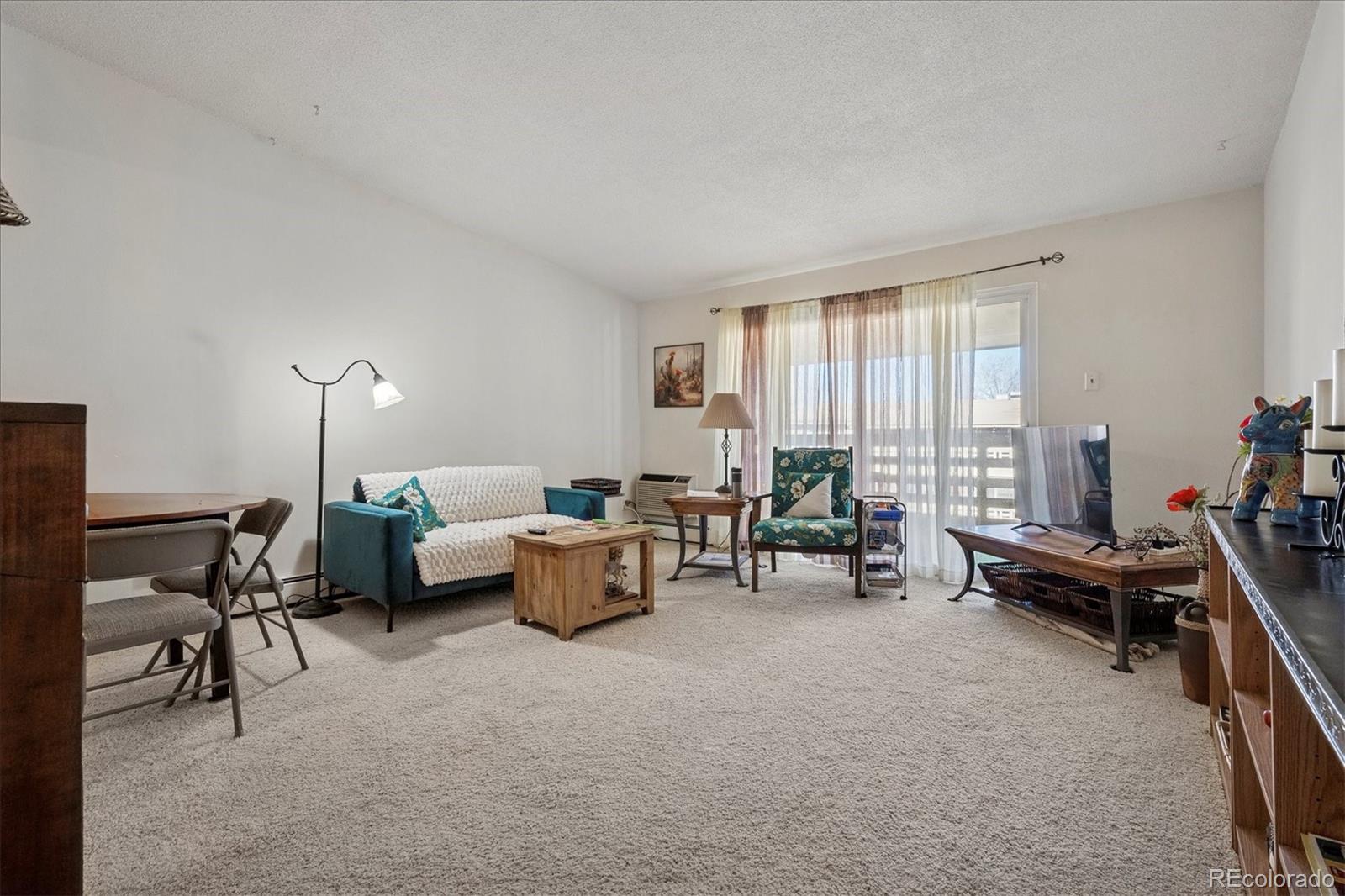 660 South Alton Way, Unit 2D Denver, CO 80247 - Photo 5 of 32 a living room with furniture and a window