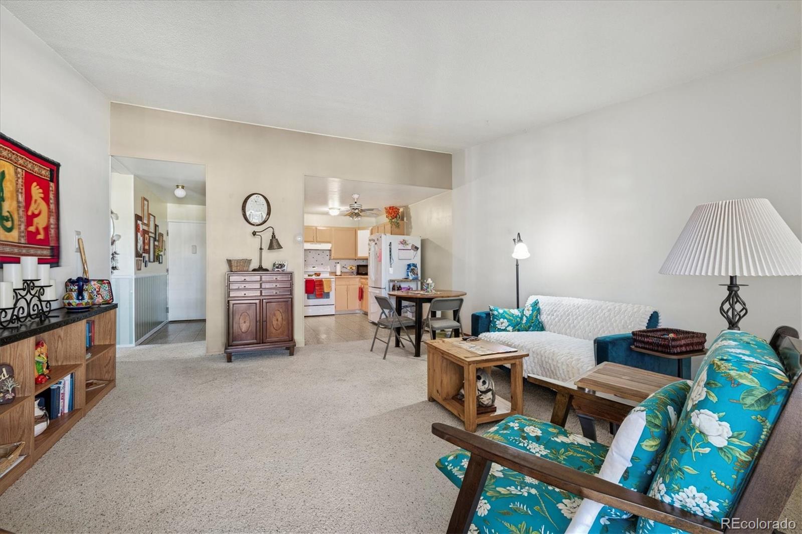 660 South Alton Way, Unit 2D Denver, CO 80247 - Photo 8 of 32 a living room with furniture a flat screen tv and a table