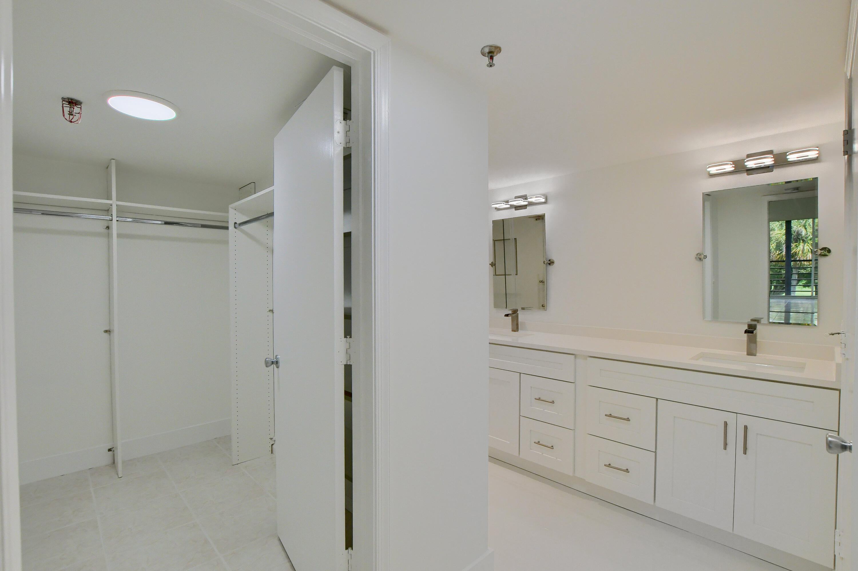 9170 Southwest 14th Street, Unit 4405 Boca Raton, FL 33428 - Photo 15 of 48 a bathroom with a double vanity sink and mirror
