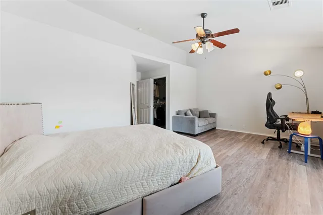 a bedroom with a bed and a chandelier