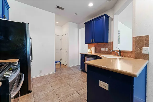 a kitchen with a sink a stove and a refrigerator