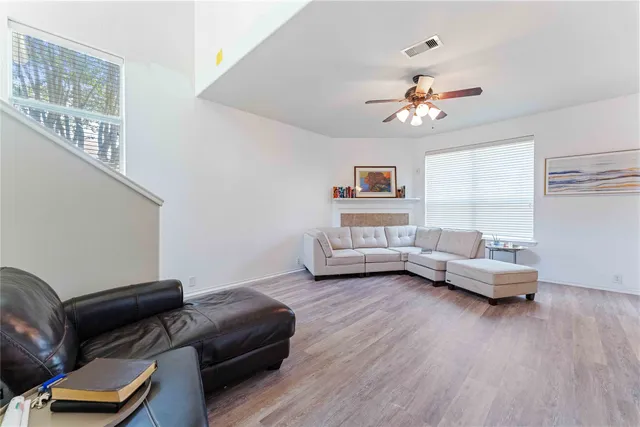 a living room with furniture and wooden floor