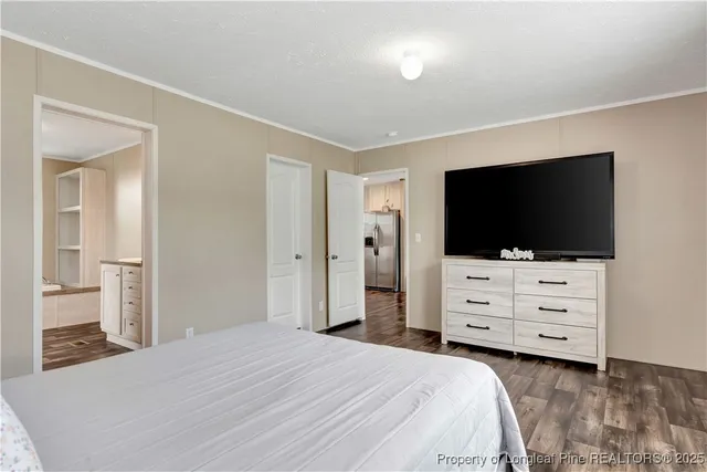 a bedroom with a bed and flat screen tv