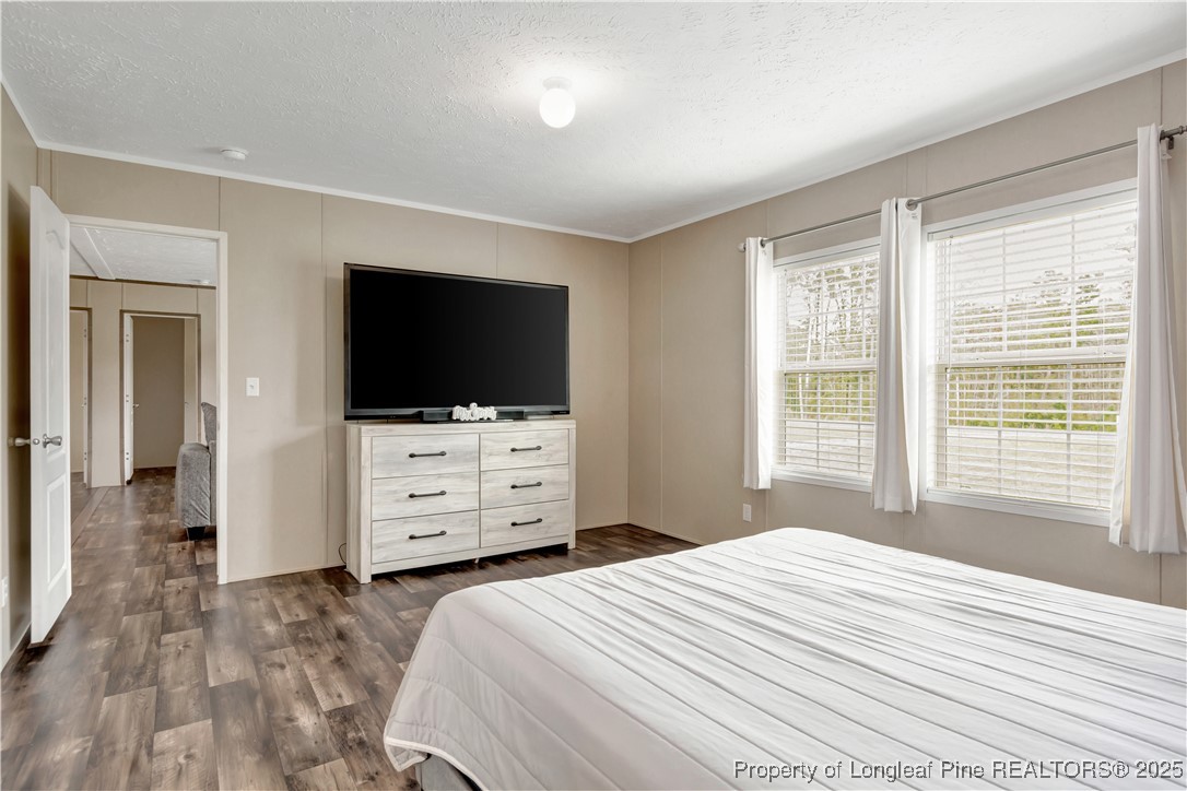 7879 Chicken Road Lumberton, NC 28360 - Photo 18 of 29 a bedroom with a bed and a flat screen tv