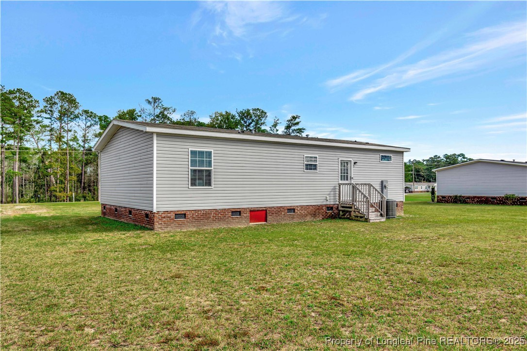 7879 Chicken Road Lumberton, NC 28360 - Photo 28 of 29 a front view of house with yard and trees in the background