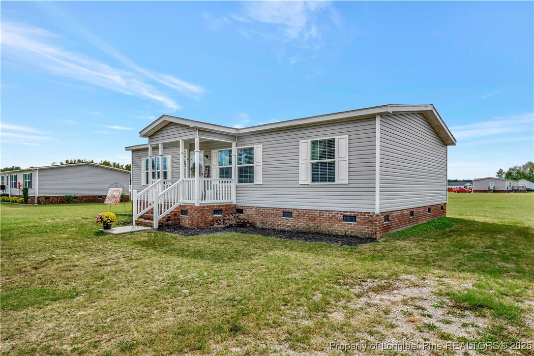 7879 Chicken Road Lumberton, NC 28360 - Photo 3 of 29 a view of a house with a backyard