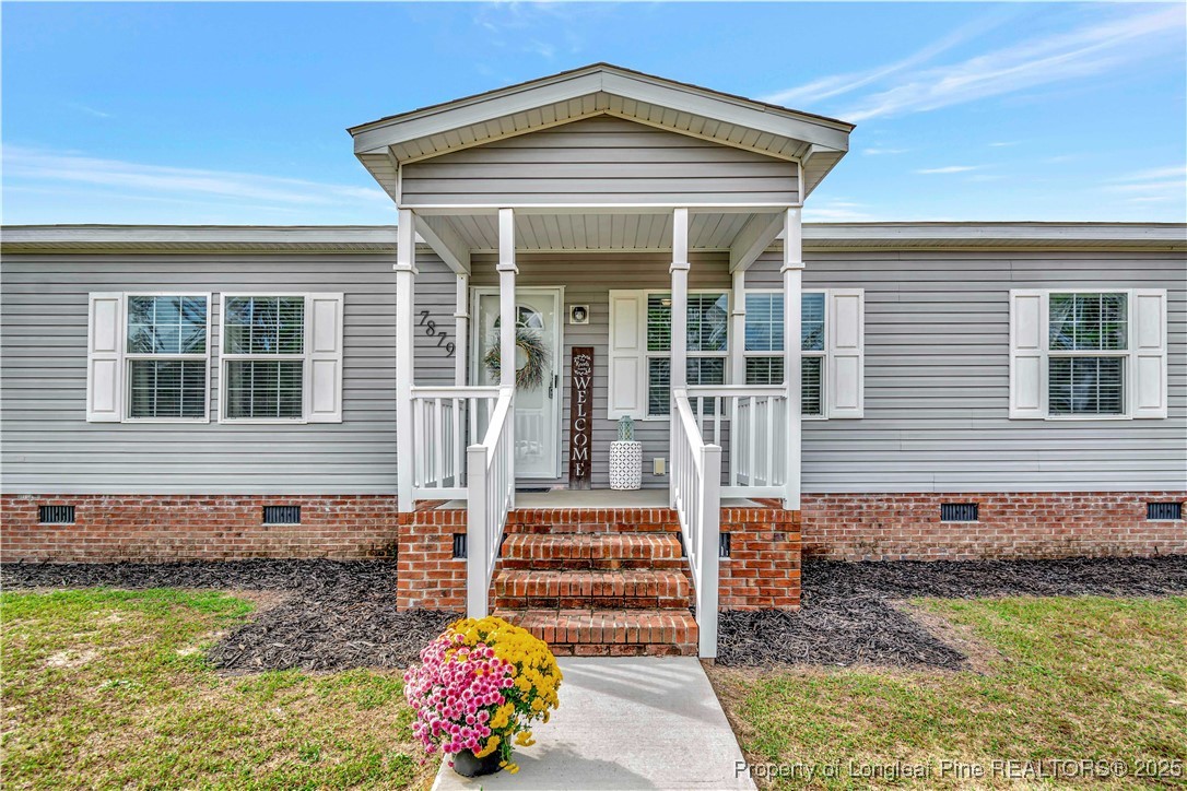 7879 Chicken Road Lumberton, NC 28360 - Photo 4 of 29 a front view of a house with a yard