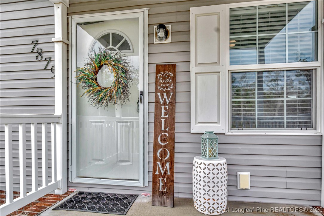7879 Chicken Road Lumberton, NC 28360 - Photo 5 of 29 a front view of a house with a door and a rug