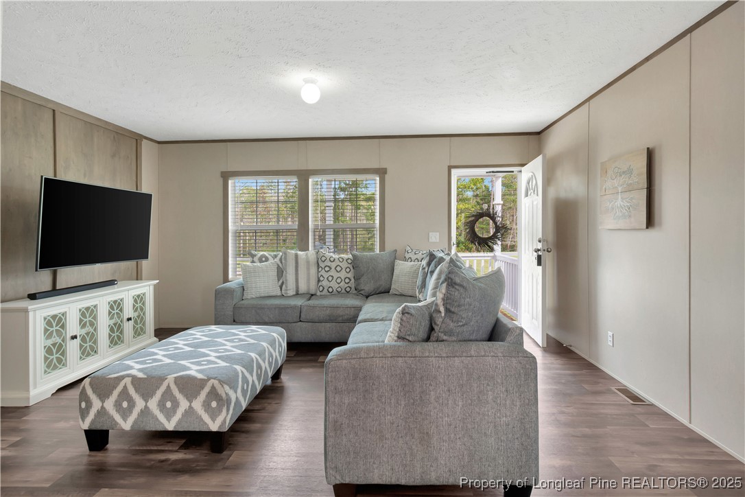 7879 Chicken Road Lumberton, NC 28360 - Photo 7 of 29 a bedroom with furniture and a flat screen tv