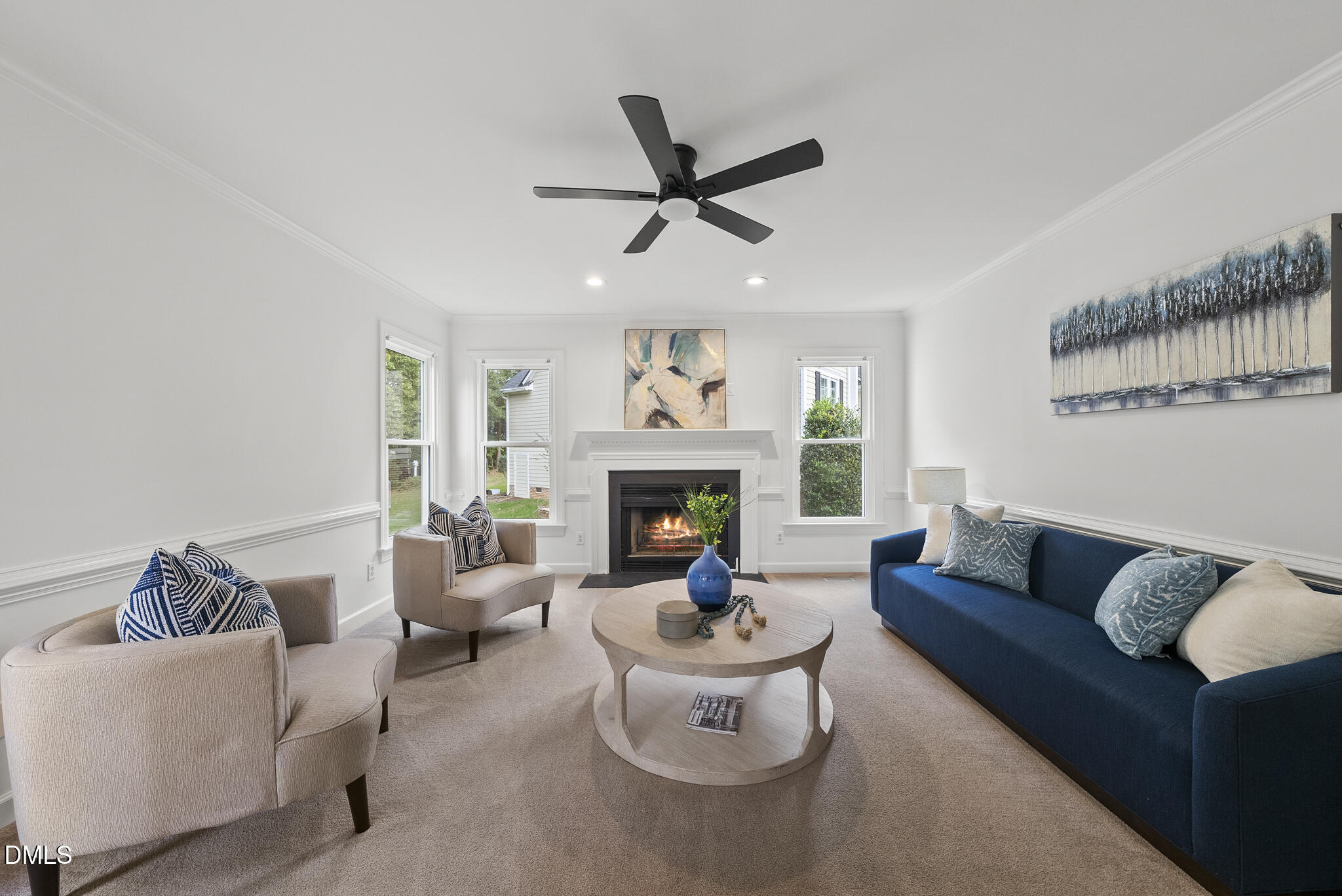 5316 Easthorpe Drive Raleigh, NC 27613 - Photo 16 of 53 a living room with furniture a fireplace and a chandelier