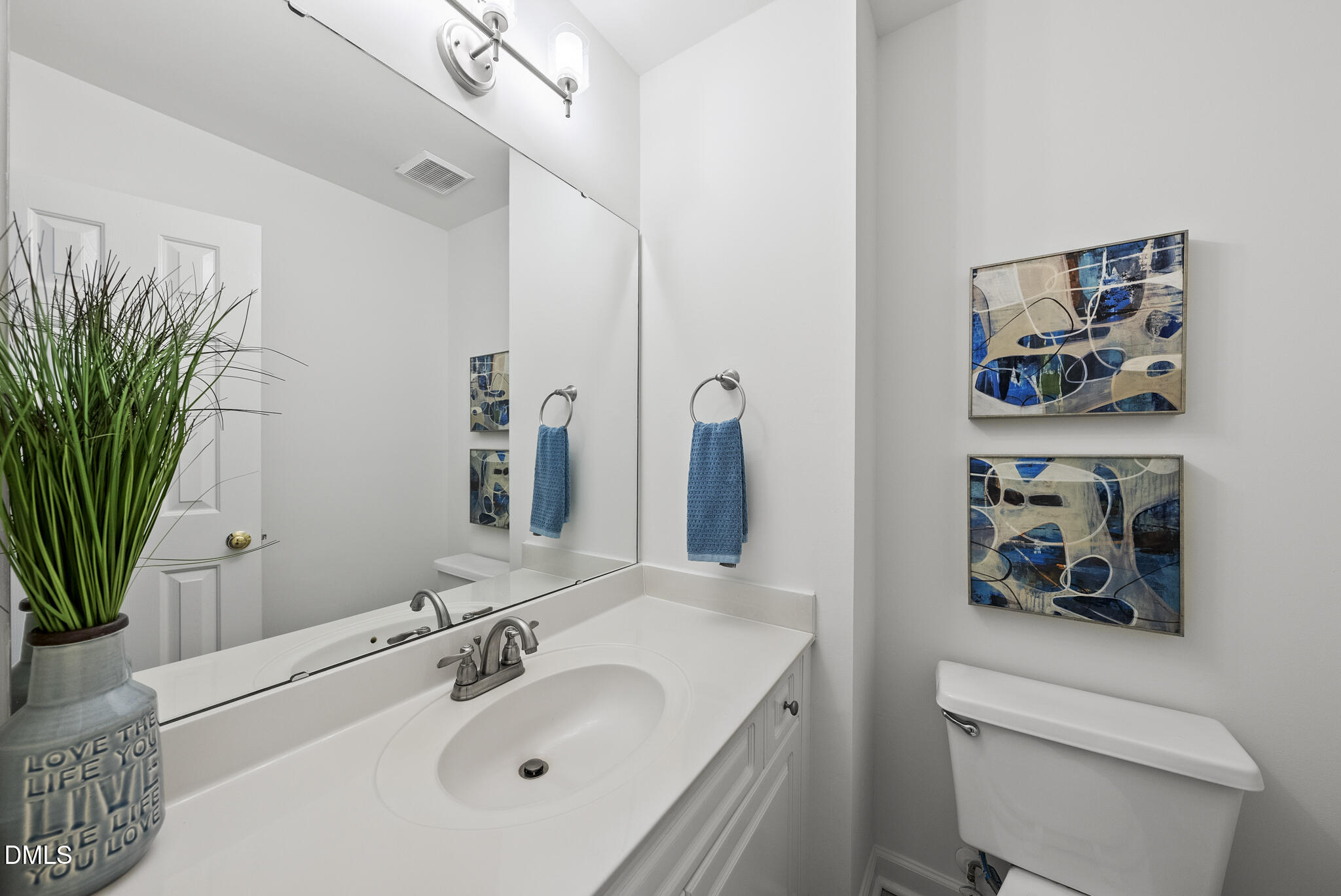 5316 Easthorpe Drive Raleigh, NC 27613 - Photo 21 of 53 a bathroom with a sink a toilet and a large mirror