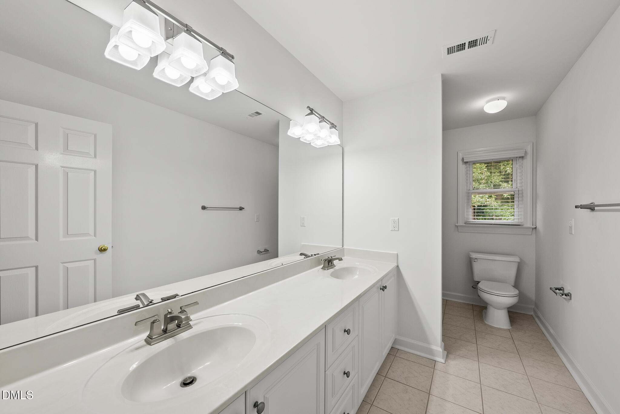5316 Easthorpe Drive Raleigh, NC 27613 - Photo 27 of 53 a bathroom with a toilet sink and mirror