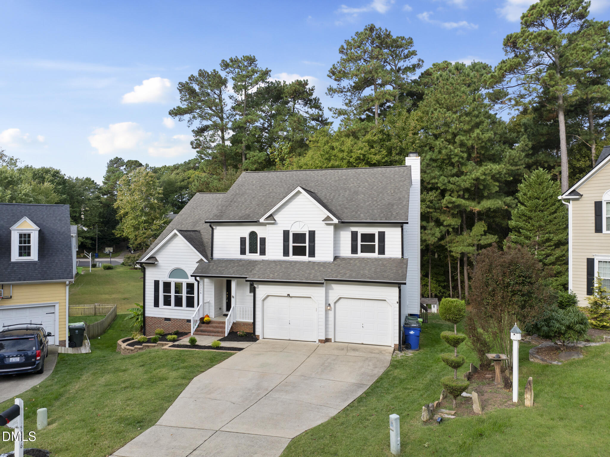 5316 Easthorpe Drive Raleigh, NC 27613 - Photo 42 of 53 a front view of a house with a garden and trees