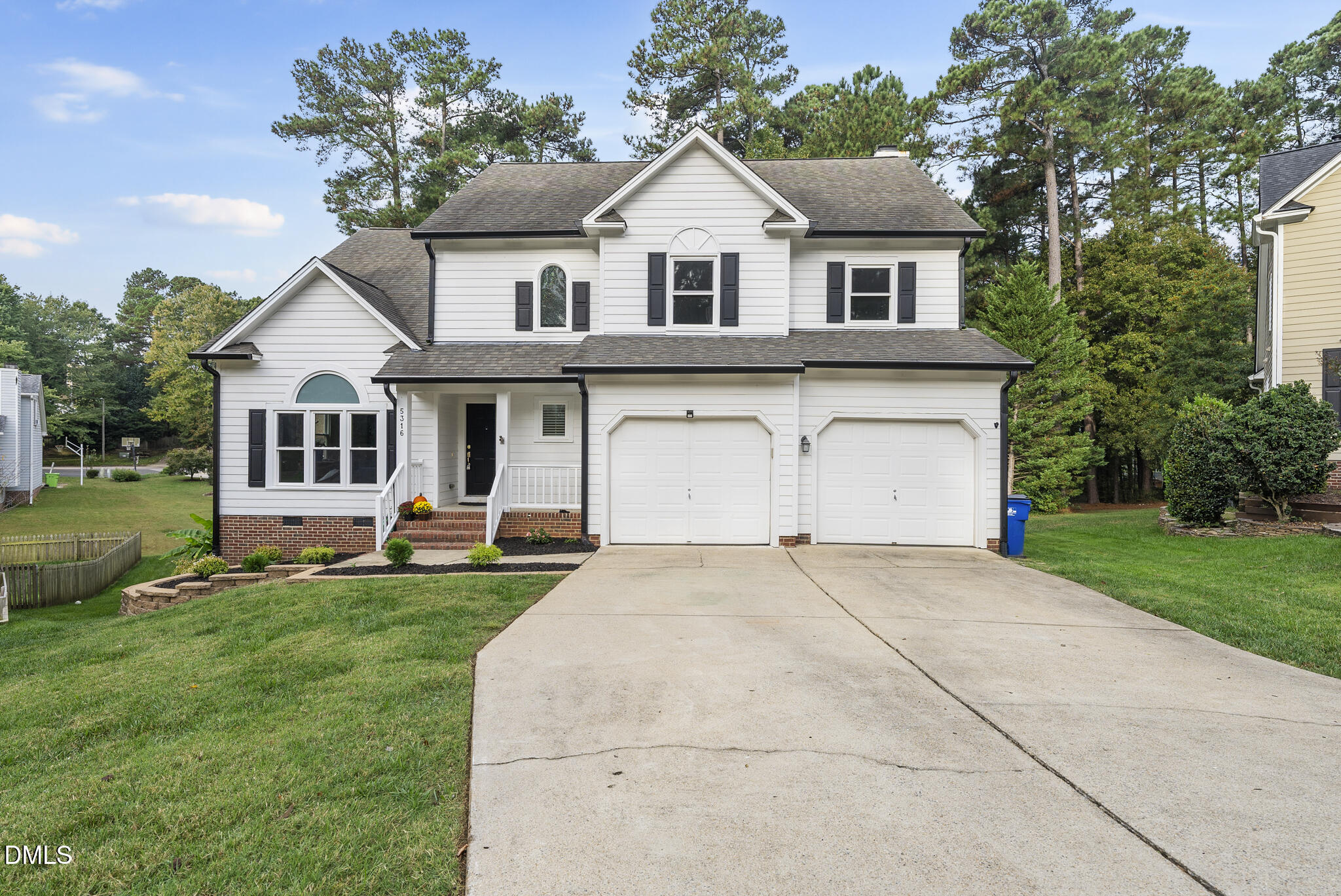 5316 Easthorpe Drive Raleigh, NC 27613 - Photo 43 of 53 a front view of a house with a garden and trees