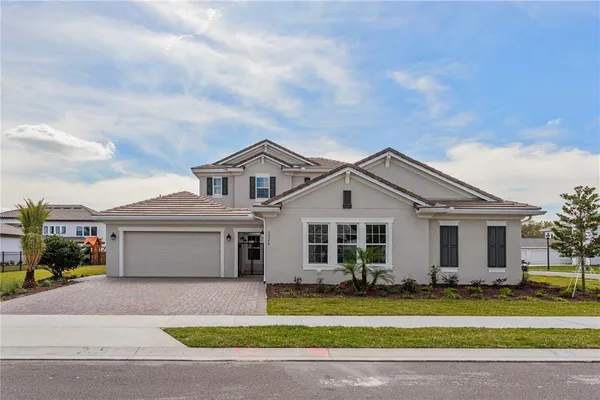 a front view of a house with a yard and garage