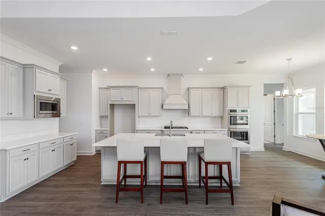 a large kitchen with cabinets table and chairs