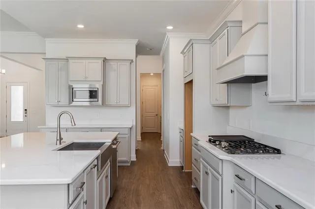 a kitchen with stainless steel appliances a sink stove and refrigerator