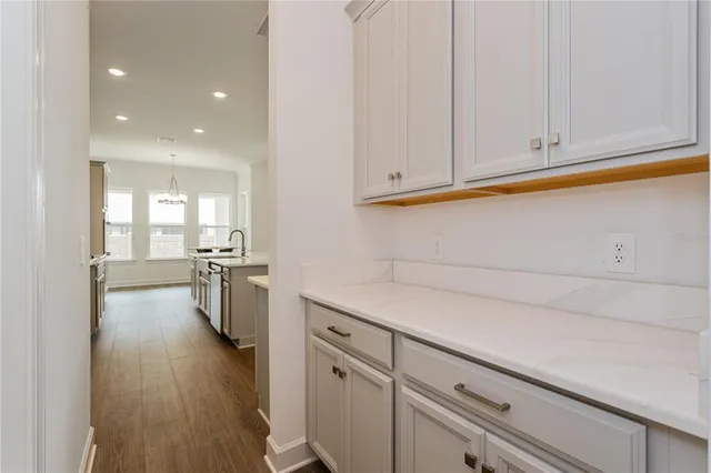 a view of a kitchen with furniture and wooden floor
