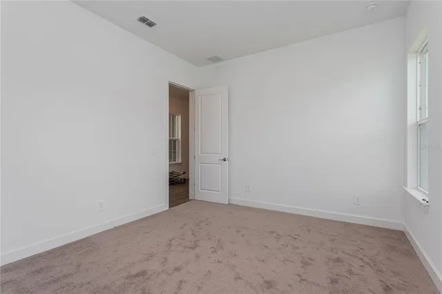a bathroom with a granite countertop sink toilet mirror and shower