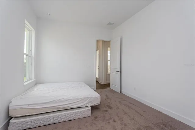 a bathroom with a granite countertop sink toilet and mirror