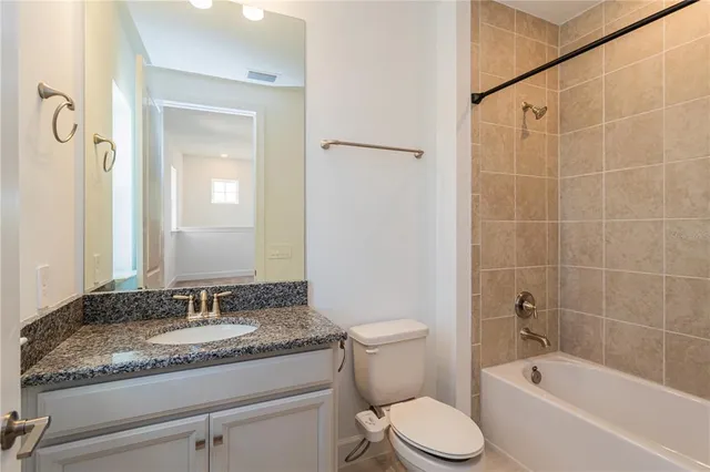 a kitchen with white cabinets and a stove