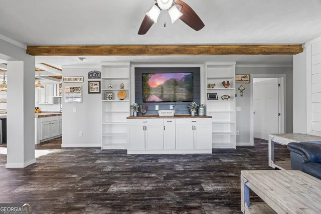 a view of a room with wooden floor and ceiling fan