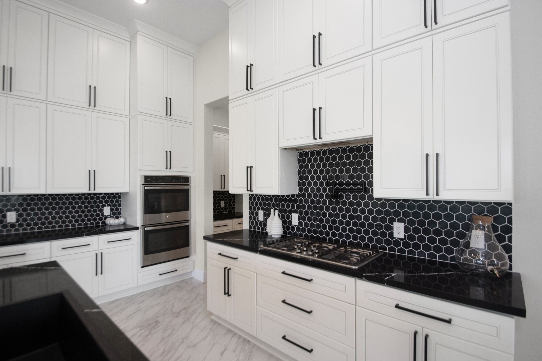 281 Brahman Trail Angleton, TX 77515 - Photo 11 of 43 a kitchen with granite countertop white cabinets and black appliances