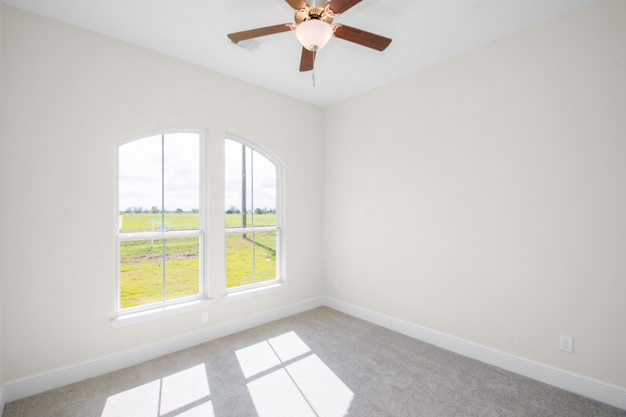 281 Brahman Trail Angleton, TX 77515 - Photo 42 of 43 an empty room with windows and fan