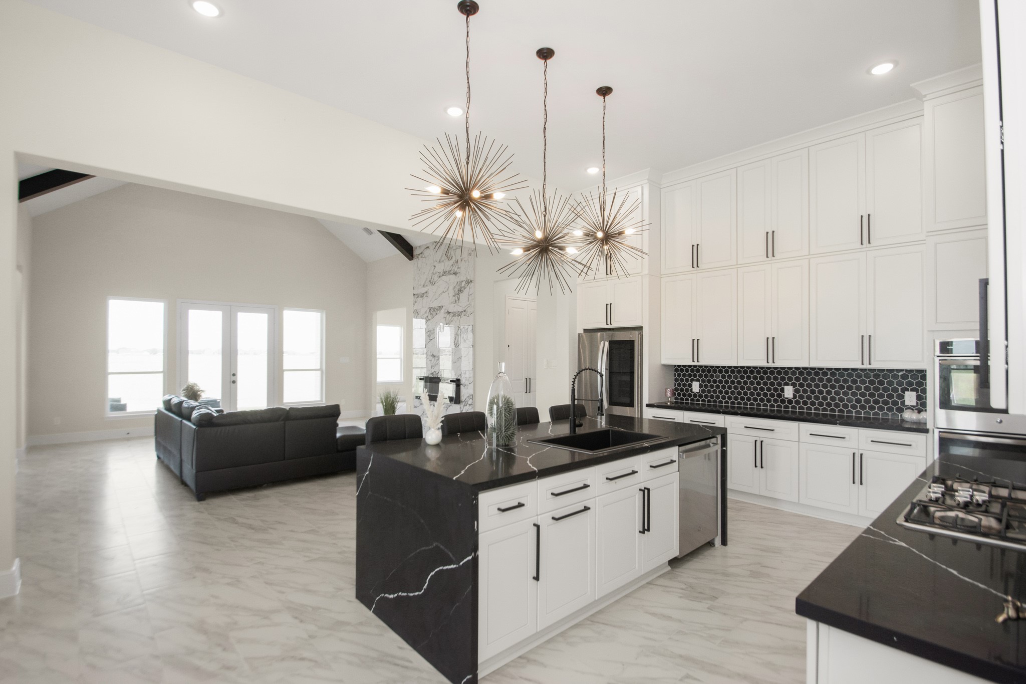 281 Brahman Trail Angleton, TX 77515 - Photo 6 of 43 a kitchen with stainless steel appliances kitchen island granite countertop a stove a sink and a refrigerator