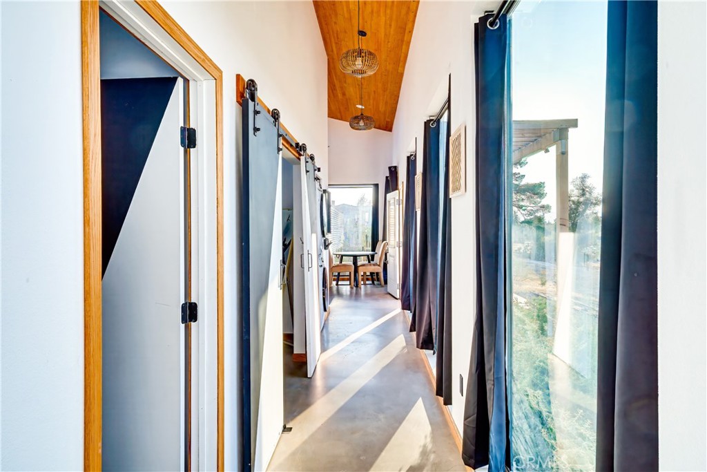 60423 La Mirada Trail Joshua Tree, CA 92252 - Photo 11 of 29 a view of a hallway with large windows