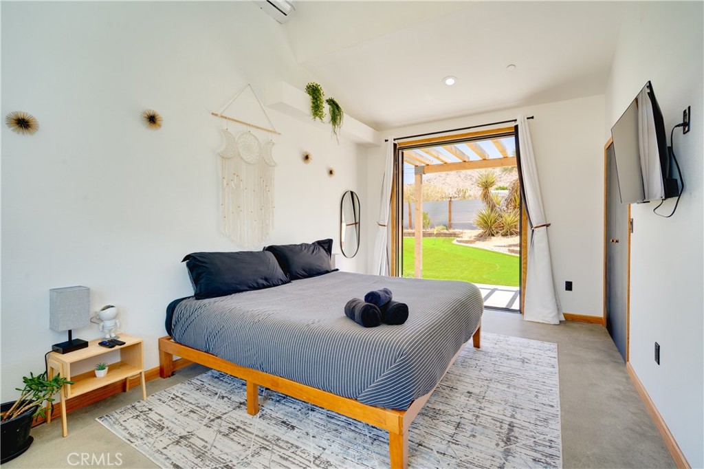 60423 La Mirada Trail Joshua Tree, CA 92252 - Photo 12 of 29 a bed room with a bed and a window
