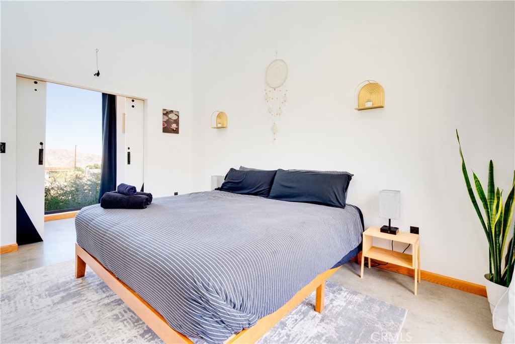 60423 La Mirada Trail Joshua Tree, CA 92252 - Photo 18 of 29 a bedroom with a bed and a window