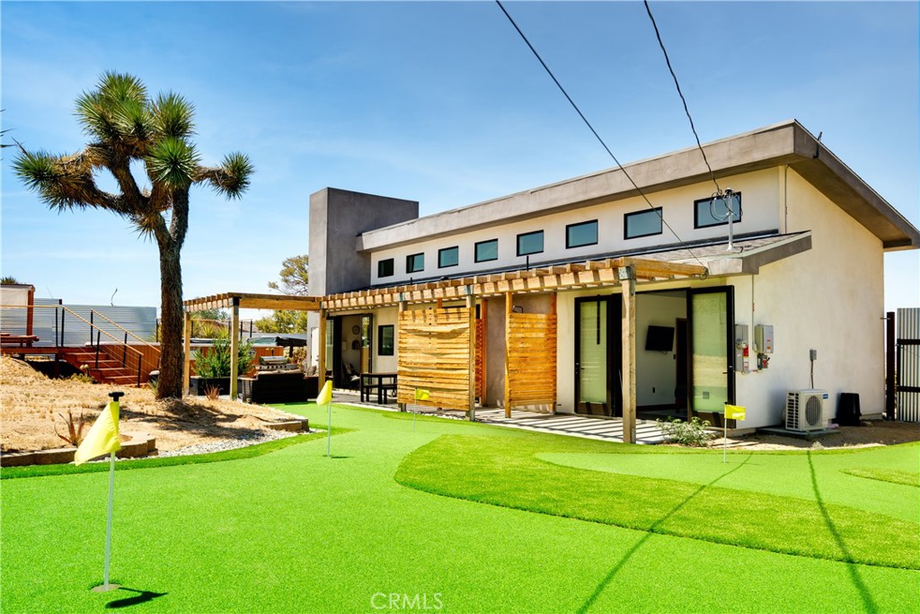 60423 La Mirada Trail Joshua Tree, CA 92252 - Photo 21 of 29 a view of a house with sitting area and garden